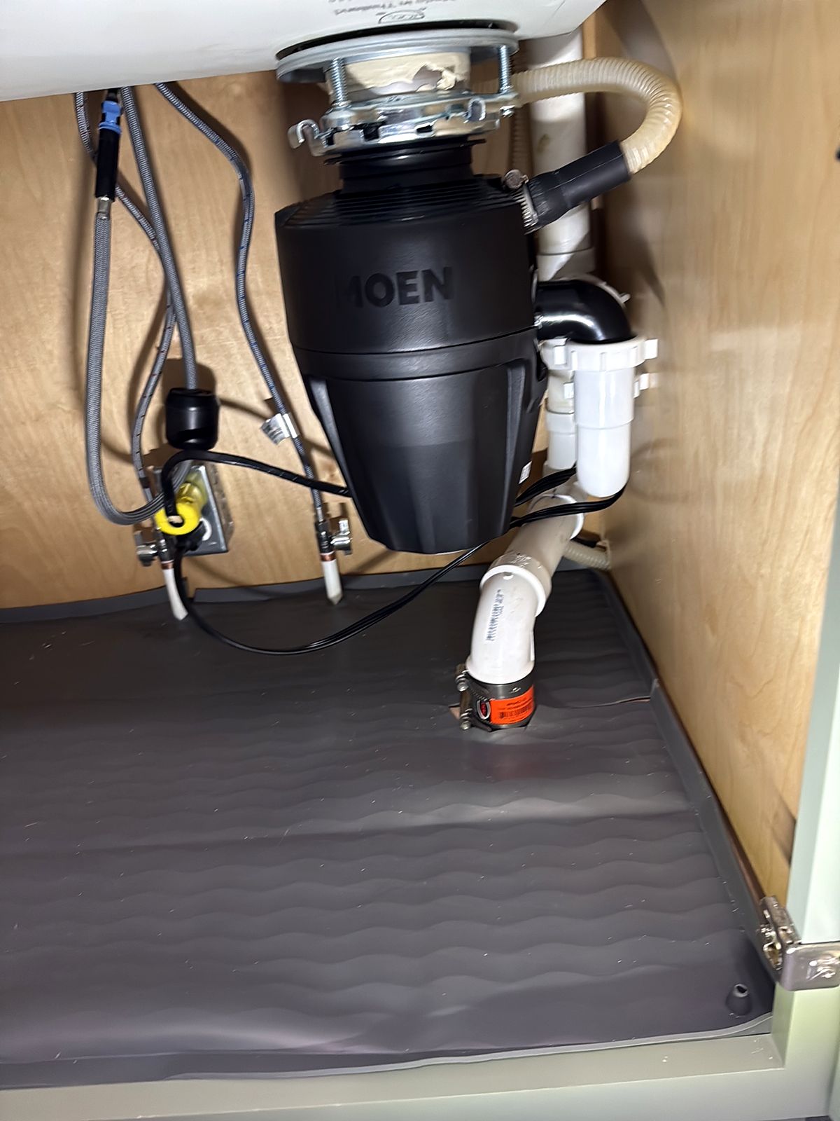 Garbage disposal installed under a kitchen sink